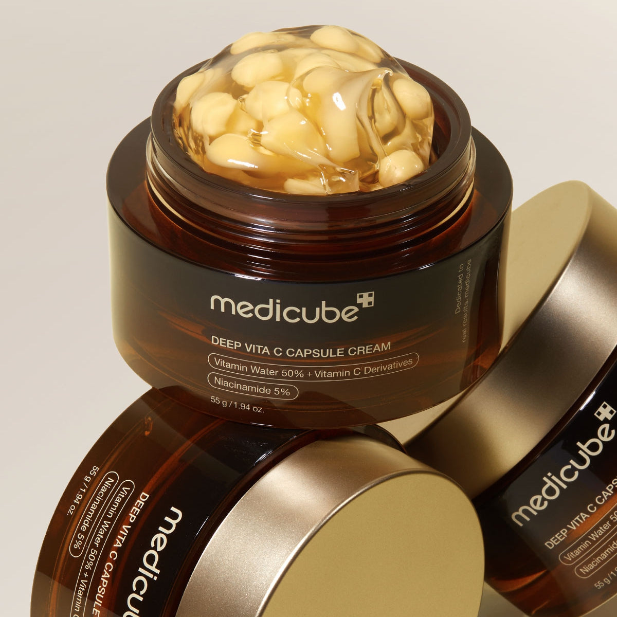 Medicube Deep Vita C Capsule Cream jar with visible contents on a beige background