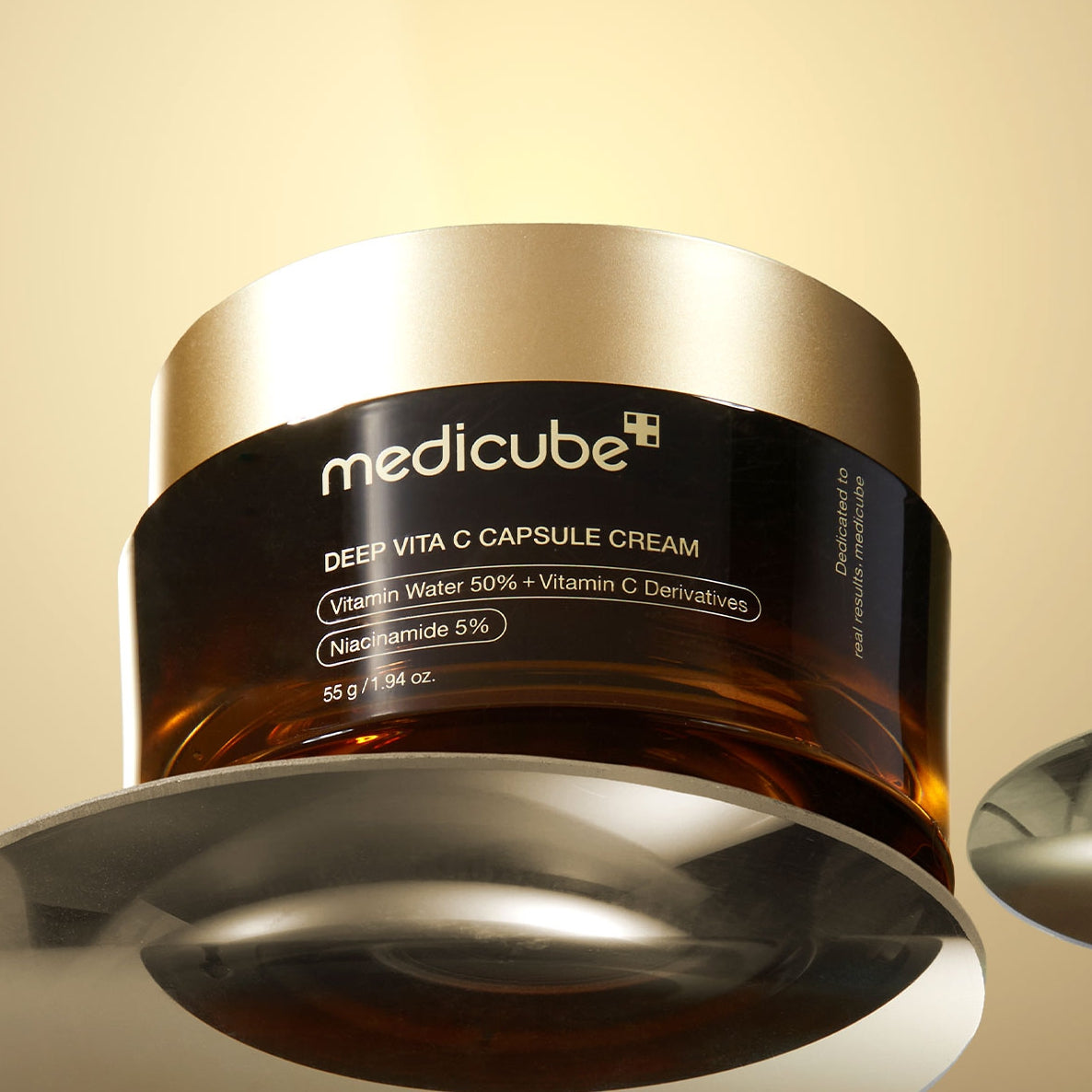 Medicube Deep Vita C Capsule Cream jar on a beige background