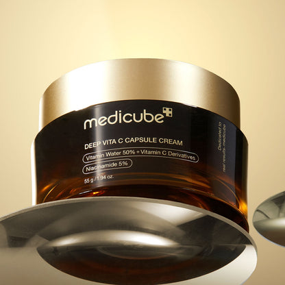 Medicube Deep Vita C Capsule Cream jar on a beige background